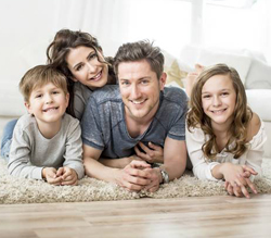 Family smiling on carpet