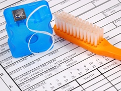 dental insurance form with toothbrush and floss