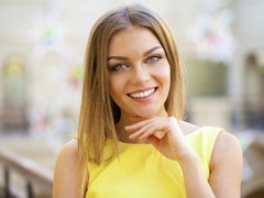 A young woman with a straight smile after going through the Invisalign Process