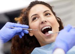 Woman getting teeth examined