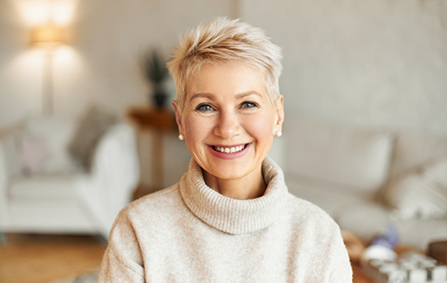 Smiling woman in cream colored sweater