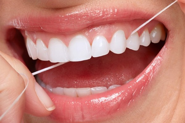 woman flossing her teeth