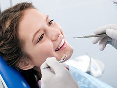 Woman receiving dental exam before dental bonding
