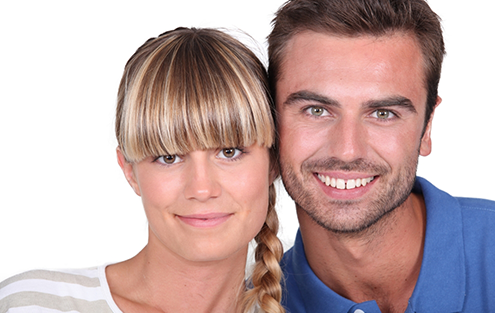 Man and woman smiling against white background