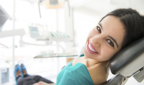 Young woman grinning in dental chair