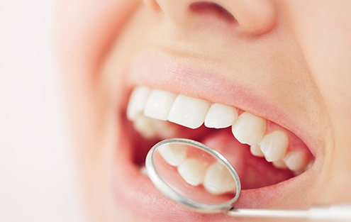 Dental mirror reflecting teeth