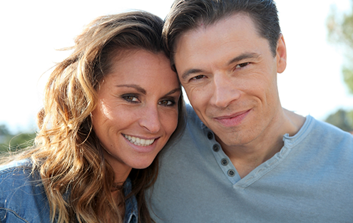 Man and woman smiling outdoors