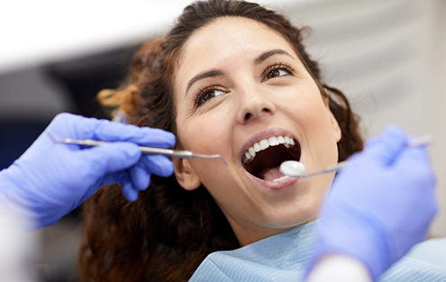 Woman having her teeth examined by a dentist