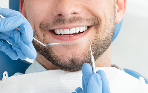 Bearded man smiling during dental checkup