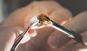 Ceramist crafting a dental crown