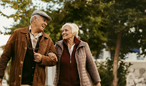 Senior couple walking arm in arm outdoors