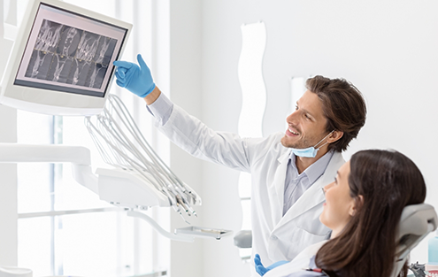 Dentist showing a patient x rays of their teeth