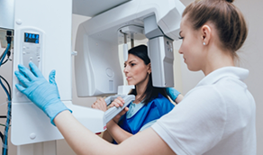 Woman getting a 3 D cone beam C T scan of her mouth and jaws