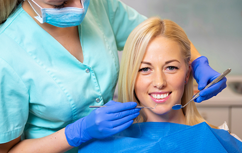 Blonde woman smiling in dental chair
