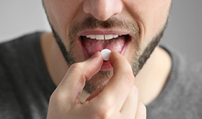 Man taking a white pill