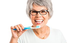 Senior woman brushing her teeth