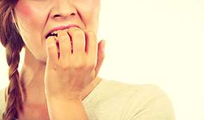 Woman nervously biting her fingernails