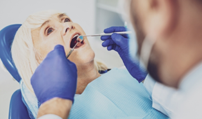 Woman having her teeth examined by her dentist