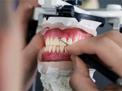 a dental lab technician creating dentures
