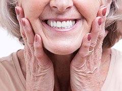 closeup of woman smiling with dentures 