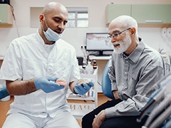 A dentist discussing denture candidacy with a patient