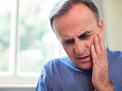 man with tooth pain needing an emergency dentist in Torrance