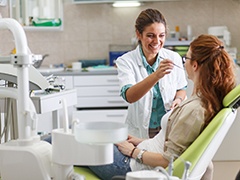 Dentist and patient happily conversing