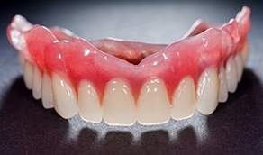 Denture against dark gray background