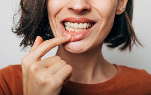 Woman pointing to her lower gums
