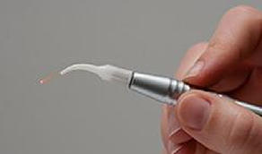Hand holding a pen like dental laser device