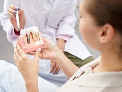 Dentist and patient discussing dental implants during consultation