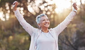 Woman stretching and smiling outdoors
