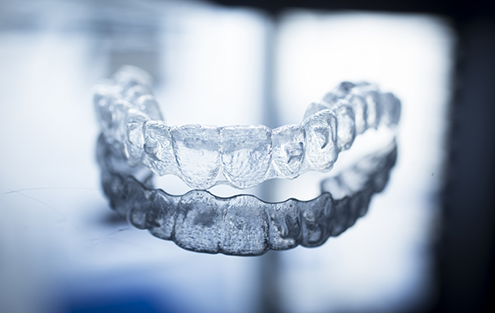 Invisalign aligner against gray background