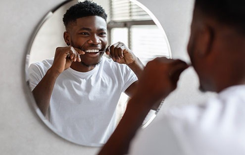 Man flossing his teeth
