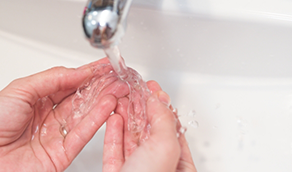 Person rinsing Invisalign in the sink