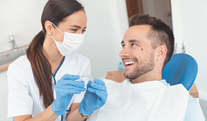 Dentist showing Invisalign to a man in the dental chair