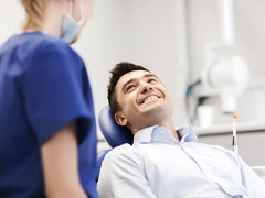 Man smiling while talking to sedation dentist in Torrance