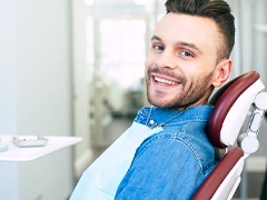 Closeup of young man smiling in dentist's office