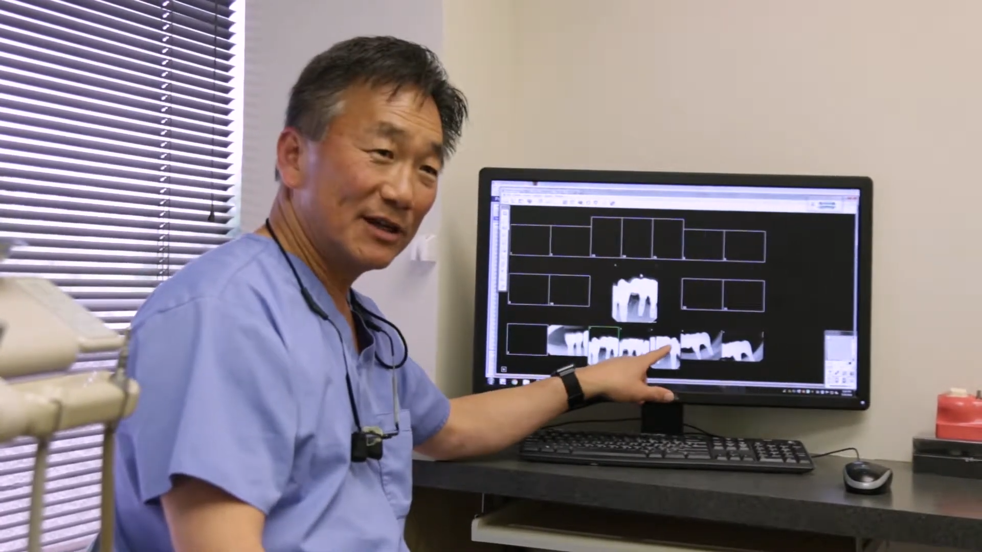 Doctor Cho showing a patient x rays of their teeth
