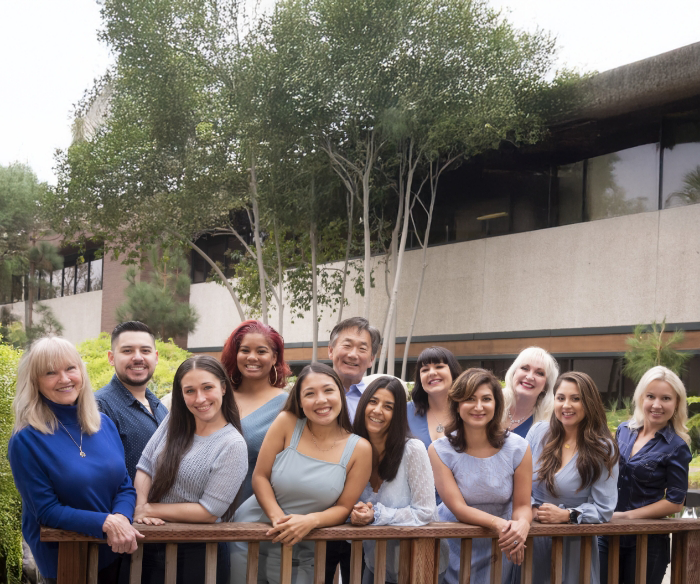 Blue Coast Dental Group team smiling in front of Torrance dental office