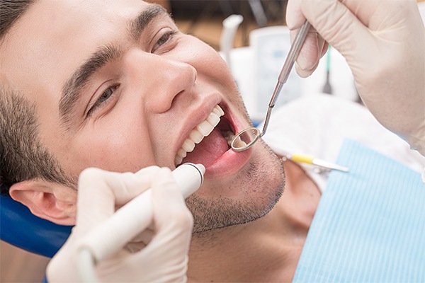 man cleaning teeth