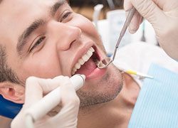 man cleaning teeth