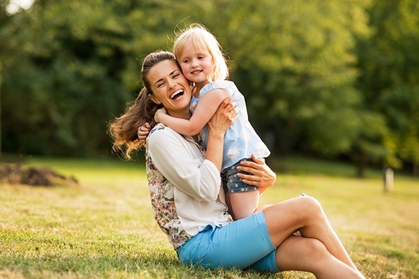 family smiling outdoors