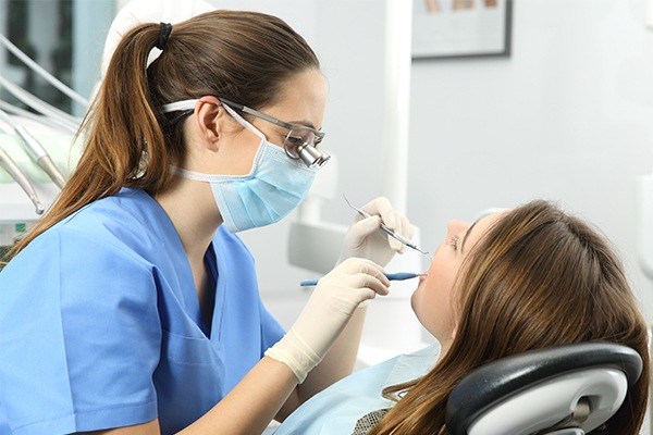 Dentist speaks with patient