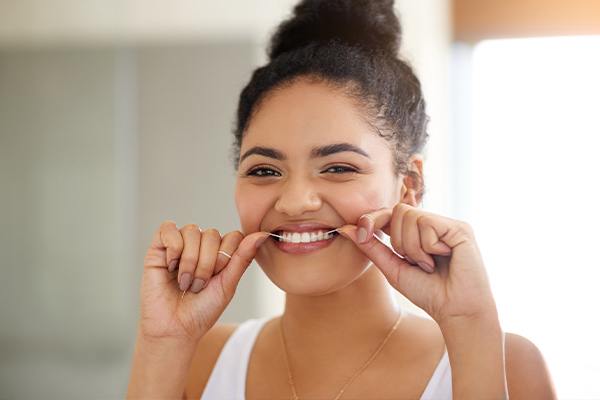 Woman flossing here teeth