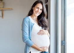 pregnant woman holding stomach