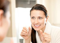 Woman flossing her teeth