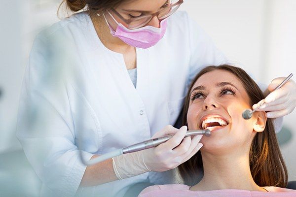 Dentist checking smile after dental crown placement