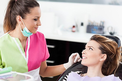 woman talking to dental hygenist