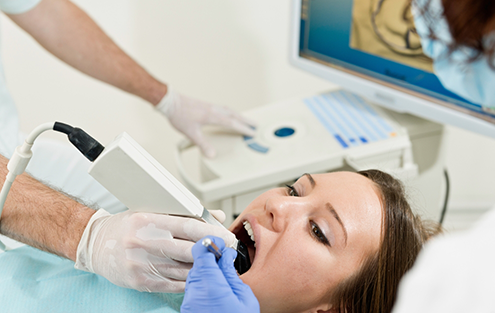 Woman in dental chair receiving an oral cancer screening